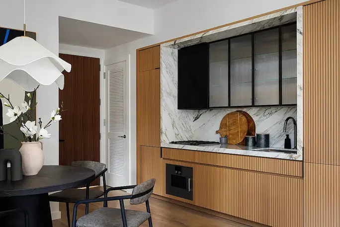 Modern kitchen with custom cabinetry at 135 East 47th Street #8D apartment for rent