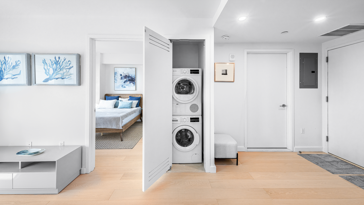 Entryway and in-unit laundry area at The Prince condo in Flushing