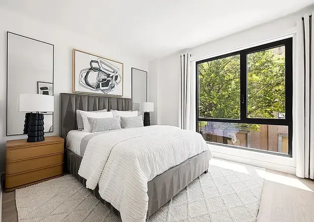 Bedroom with large windows and natural light in a 1-bedroom condo at Noble LIC, Long Island City