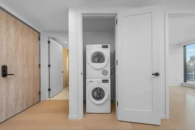 In-unit Bosch washer and dryer closet in a modern Long Island City apartment