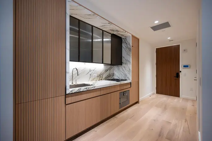 Open kitchen with marble backsplash at 135 East 47th Street #8F rental apartment