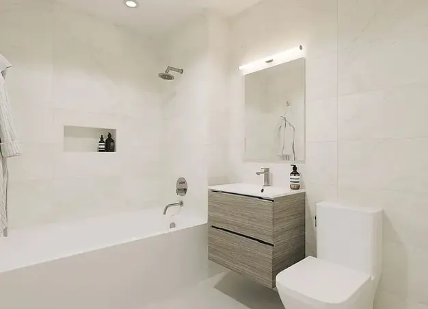 Contemporary bathroom with porcelain tile finishes in a Noble LIC 1-bedroom apartment