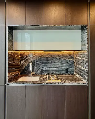 Modern kitchen detail at 125 Greenwich Street condominium with custom cabinetry and stone backsplash