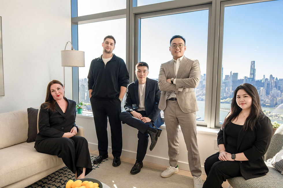 Mario Wang with members of his team beside large windows