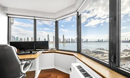 Corner living space with city views in a 1-bedroom condo at 415 East 37th Street #11A, New York City, listed by Acre NY Realty
