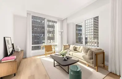 Sun-filled one-bedroom living room at 135 East 47th Street #16G, Midtown Manhattan, New York