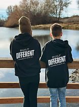 two young teens with sweatshirts that say "Built Different" on the back
