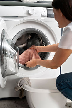 woman-taking-clothes-from-washing-machine.jpg