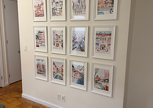 Gallery wall with multiple framed pictures professionally mounted on the wall