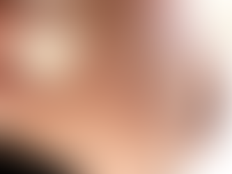 Close-up of a hand holding a paper heart near a pregnant belly. Soft light, calm mood. Logo text: Louisville Prenatal Massage.