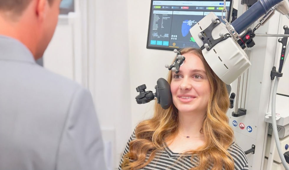 Close-up view of TMS coil positioned on patient's head during therapy session