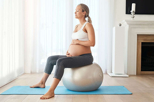 Pregnant-Woman-Sitting-On-Yoga-Ball_edited.jpg