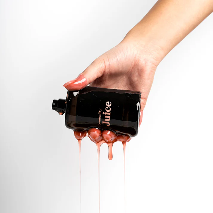Commodity Juice perfume bottle featuring strawberry, rhubarb and raspberry notes with amberwood base, celebrating first anniversary