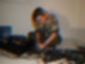 Cai Gwilym Pritchard adjusting audio equipment glitched photo