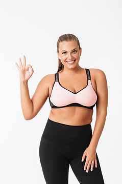 beautiful-plump-girl-sporty-top-leggings-joyfully-showing-ok-gesture-while-looking-camera-