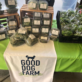 Good Dog Farm display table with labeled produce