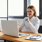 medium-shot-smiley-doctor-with-laptop.jpg