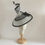 Thumbnail: Black and White -Ascot spiral hat in black and white sinamay on a white button