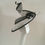 Thumbnail: Black and White -Ascot spiral hat in black and white sinamay on a white button