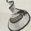 Thumbnail: Black and White -Ascot spiral hat in black and white sinamay on a white button