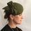 Thumbnail: Sarah - Green felt headpiece on a button base with green felt bow