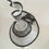 Thumbnail: Black and White -Ascot spiral hat in black and white sinamay on a white button
