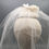 Thumbnail: Roberta - White lace and silk button headpiece with a shoulder length veil