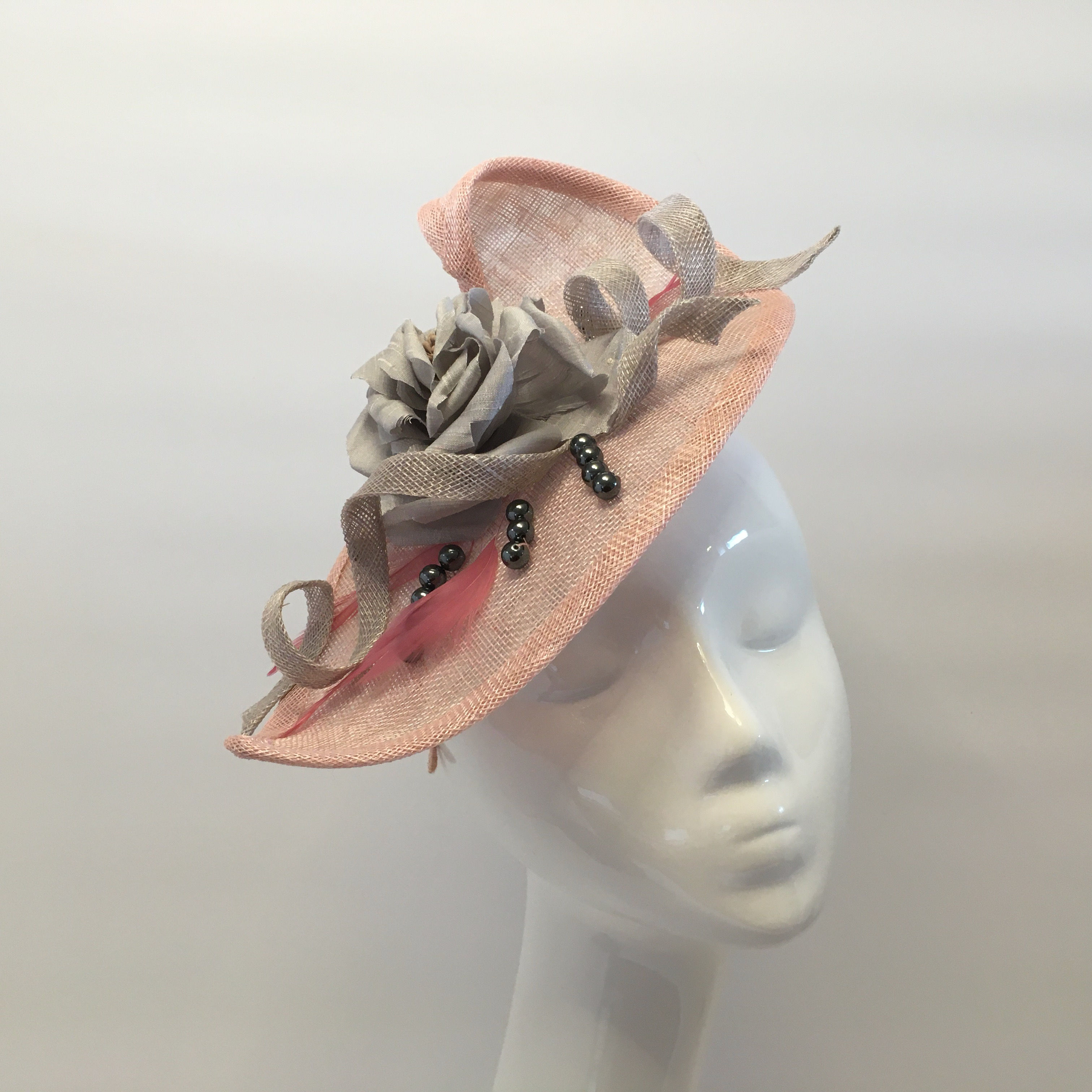 Storm -Pink sinamay straw headpiece on a headband