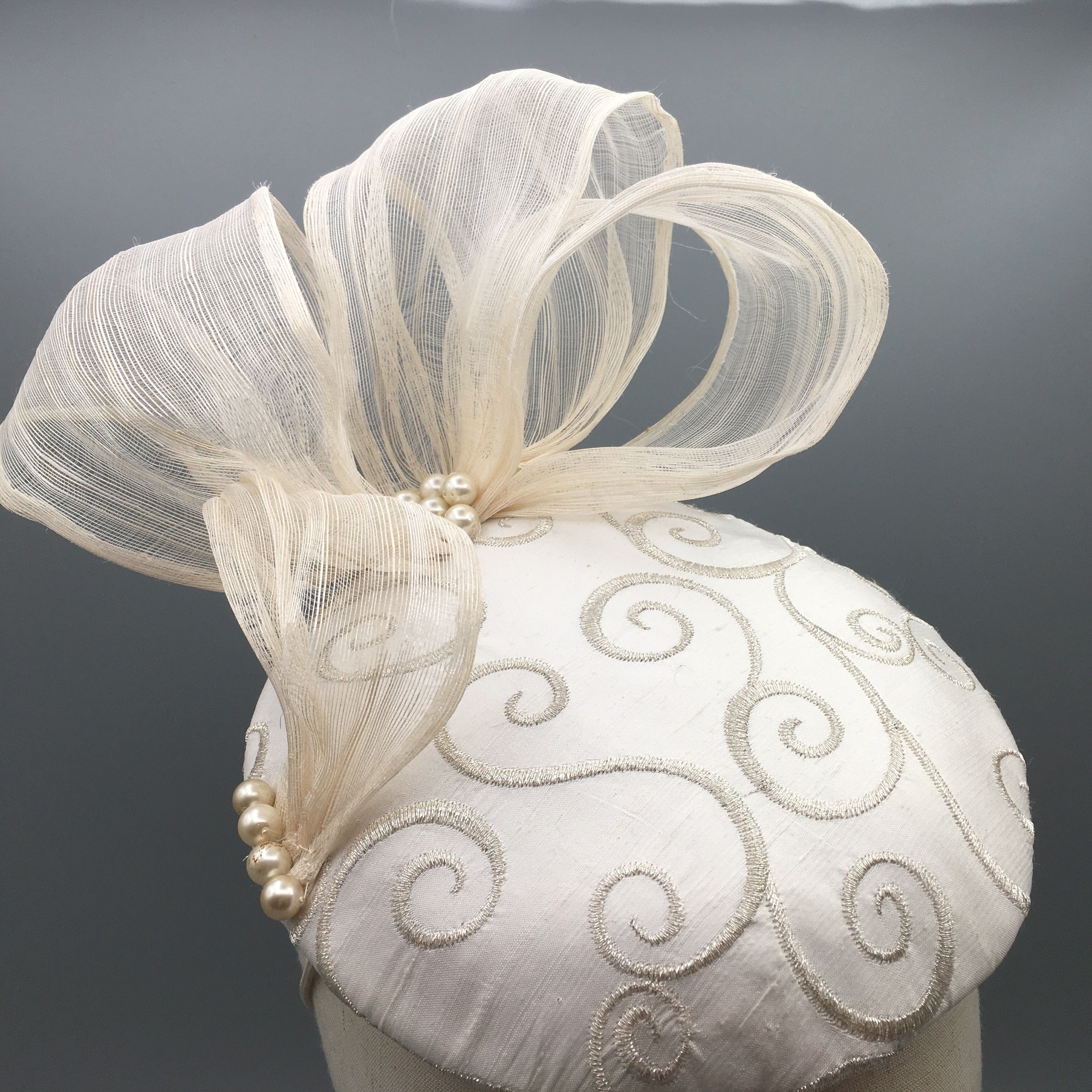 Marji - Cream embroidered silk button headpiece with silk abaca bow and pearls