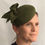 Thumbnail: Sarah - Green felt headpiece on a button base with green felt bow
