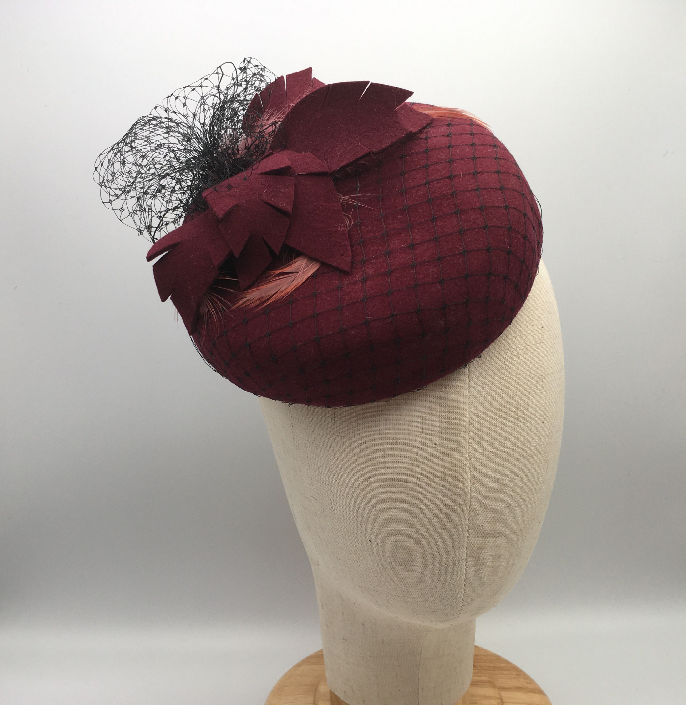 Edith - Burgundy wool felt button measuring with black veiling, felt and feather