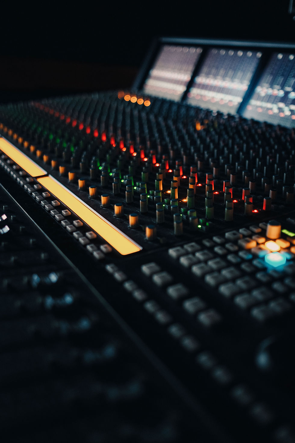 Vue détaillée d’une console SSL Duality professionnelle aux Linster Studios, avec faders illuminés et boutons codés par couleur.
