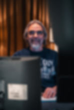 Portrait senior team member and partner at Linster Studios, Werner Pensaert, in front of studio monitors – representing expertise and passion for sound.