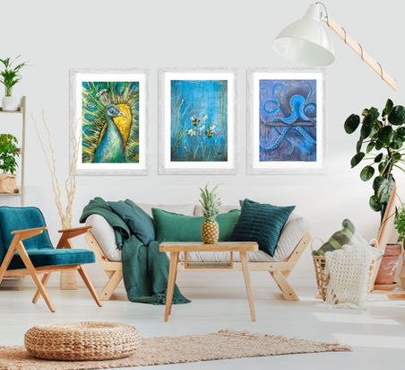 Three framed artworks above a sofa in a modern living room.