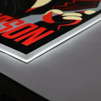 Close-up of a custom light box with an illuminated poster edge.