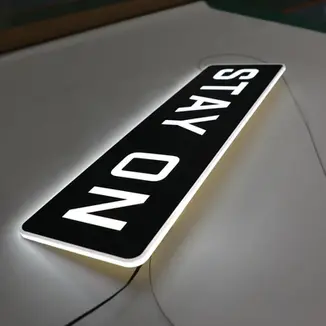 Illuminated custom light box with STAY ON text