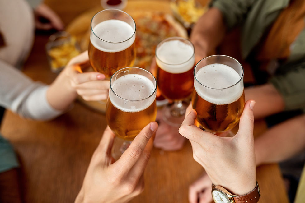 Friends toasting beers at a live music restaurant in Penang