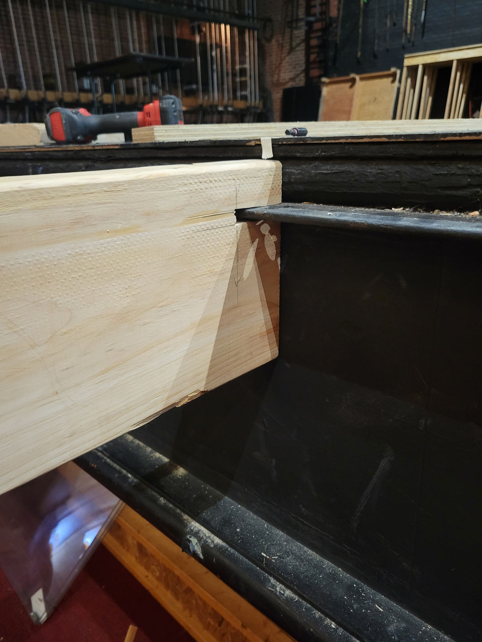 Notches cut into 2x8 to hang on iron