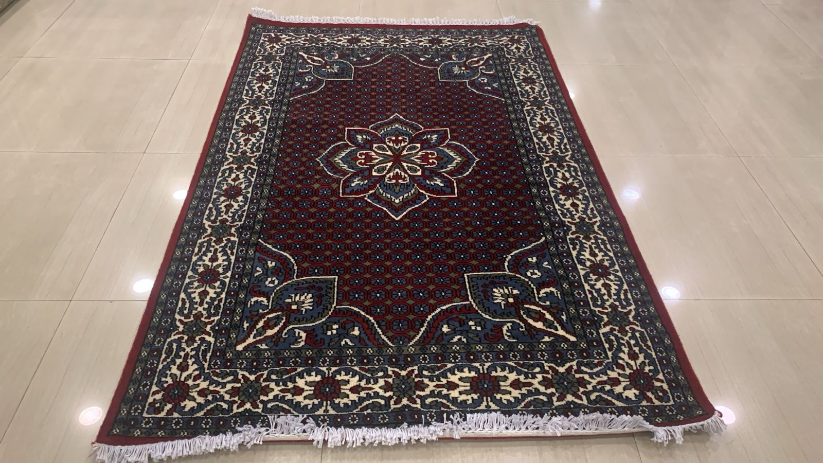 Wool and silk blend carpet 6 feet by 4 feet red with geometric border