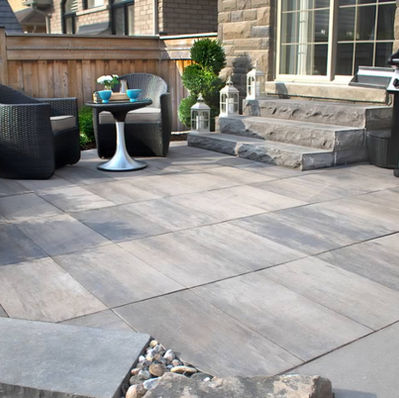 Paved patio with outdoor seating and barbecue grill