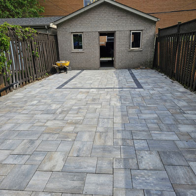 Newly paved backyard with interlocking pavers and a shed