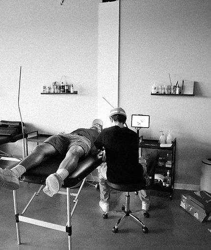 Tattoo artist tattoing a client's arm