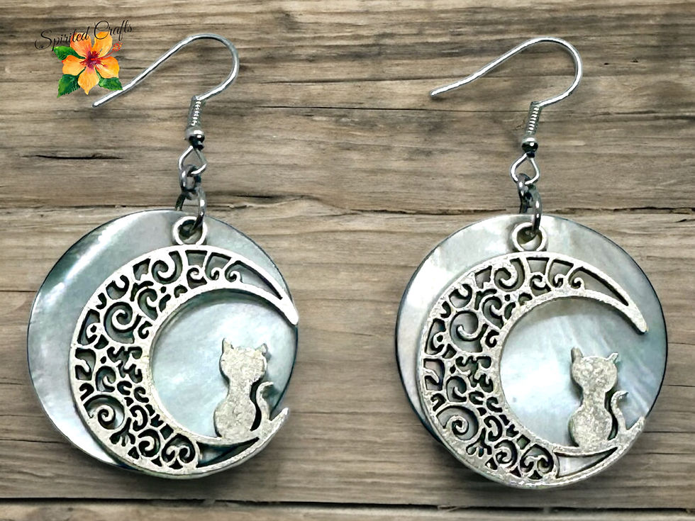 Kitty Moon Shell earrings with a wood background