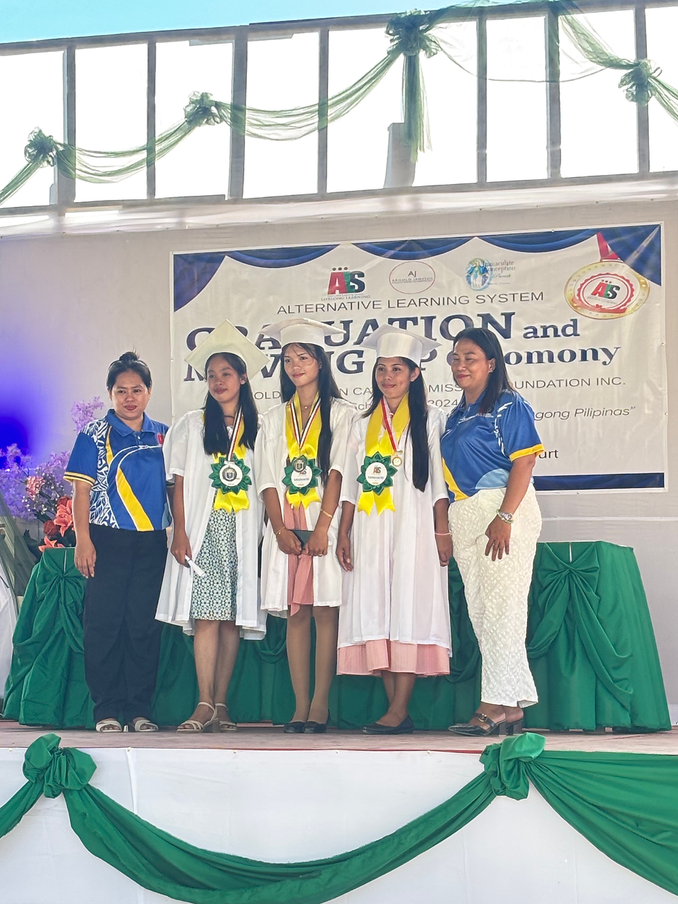 Arnold Janssen learning facilitators Ma’am Emelyn and Ma’am Nel Rose with their graduated students