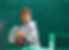 Little tennis player on a blurred green