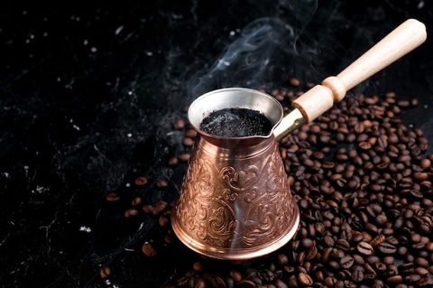 turkish-jezve-coffee-pot-with-hot-coffee-coffee-beans_105694-474.jpeg