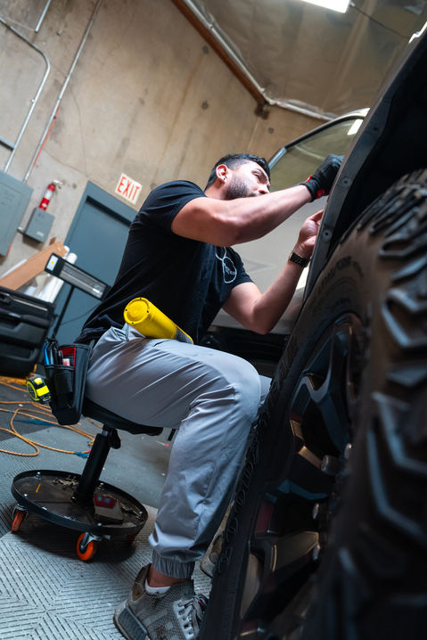 Technician applying vinyl wrap to truck at Innovated Design in Temecula, CA