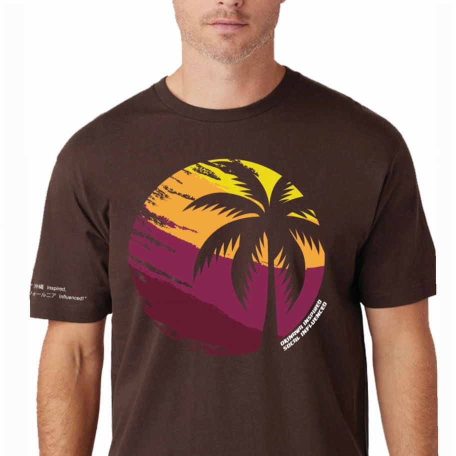 Man wearing Cacao Crew Neck Tee/Sunset Palm Print, graphic on brown shirt.