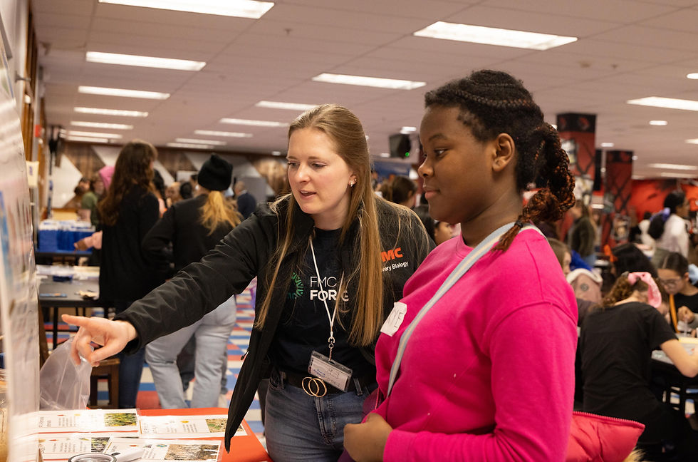 FMC volunteer describing careers in agricultural sciences to the girls.