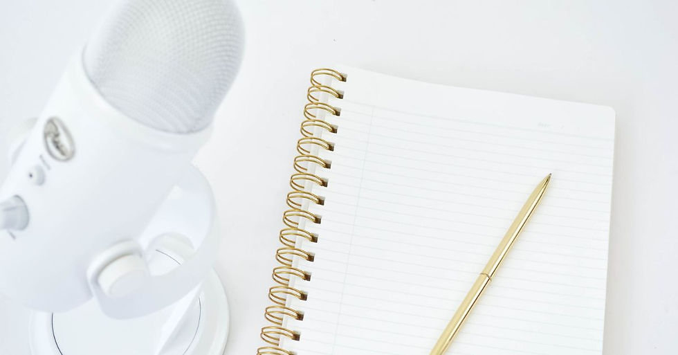 Flat lay of podcasting setup with microphone and notebook, symbolizing personal brand platform building